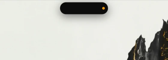 The idle pill with an amber dot showing the microphone is in use